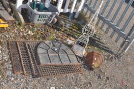 A COLLECTION OF CAST IRON ITEMS, including four drain grates, all 59cm square, an arched window, a