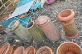 FIVE TALL CHIMNEY POTS, including three terracotta at 60cm high, the largest being 80cm high.