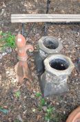TWO CHIMNEY POTS AND A TERRACOTTA RIDGE TILE, with fleur de lys top and leaf conical body (3).