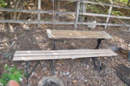 A VICTORIAN CAST IRON TABLE BASE, with a narrow oak planked top, 127cm long, 31cm deep, and a