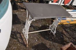 AN EDWARDIAN CAST IRON TABLE BASE, with a recent slate top, width 86cm, depth 46cm, height 74cm.