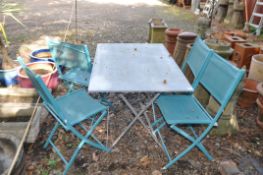 A MODERN FOLDING METAL TABLE AND FOUR CHAIRS, table width 110cm, depth 70cm, height 70cm.