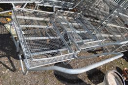 A PAIR OF GALVANISED TROLLEYS, with mesh beds and sides, two wheels and a handle, bed width 70cm,