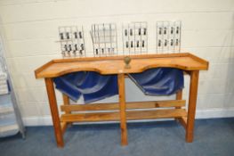 A PINE JEWELLERY MAKERS WORKBENCH with two cut outs, galleried top, undershelf and four wire