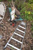 A CANVAS WHEELBARROW, an aluminium step ladder and garden tools including rakes, forks, shovels etc