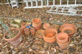 A COLLECTION OF MOSTLY TERRACOTTA PLANT POTS of varying sizes and shapes the largest being 37cm in