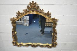 A REPRODUCTION ROCOCO STYLE GILT FRAMED OVERMANTEL MIRROR, with open foliate decoration, 120cm x