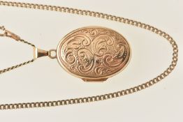 A 9CT GOLD OVAL LOCKET PENDANT WITH CURB LINK CHAIN, the locket decorated with a scrolling foliate