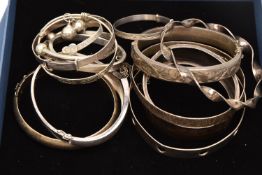 A SMALL BOX OF ASSORTED BANGLES, of various designs and styles, to include six silver hallmarked