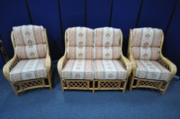 A WICKER CONSERVATORY SUITE, with floral cushions, comprising a two seater sofa, width 123cm, and
