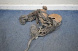 A VINTAGE SADDLE, with a wooden frame and leather accessories, condition report: marks, scuffs,