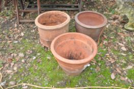 THREE LARGE TERRACOTTA GARDEN PLANT POTS including one with a glazed finish 51cm in diameter (3)