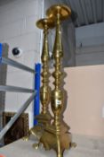A PAIR OF LARGE BRASS VINTAGE CANDLE STANDS, featuring turned column detail, triangular base with