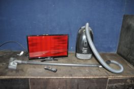 A PANASONIC TX-24E302B 24in TV with remote and a Panasonic vacuum cleaner (both PAT pass and