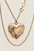 A 9CT GOLD HEART LOCKET PENDANT WITH CHAIN, the floral detailed heart locket opens to reveal two