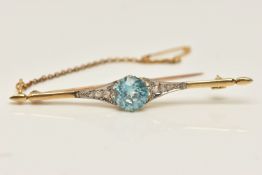 A YELLOW METAL BLUE ZIRCON AND DIAMOND SET BAR BROOCH, set with a central circular cut blue