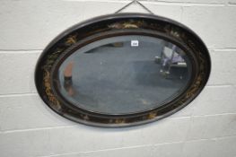 AN OVAL ORIENTAL MIRROR, with chinoiserie details, and a bevelled mirror plate, width 91cm x