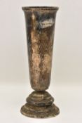 A GEORGE VI SILVER VASE, heavily tarnished, hammer effect tapering form, on a stepped round base,