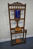 AN EARLY 20TH CENTURY OAK HALL STAND, with seven hooks surrounding a rectangular bevelled mirror,