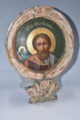 A CIRCULAR 'ST MARK THE EVANGELIST' ICON with a carved floral finial to the base, an image of St