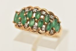A 9CT GOLD EMERALD AND DIAMOND RING, set with twelve marquise cut emeralds and ten small single
