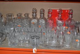 A GROUP OF CUT GLASSWARE, comprising decanters (some have stoppers missing), jugs, vases, posy bowls