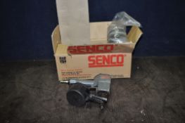 A SENCO PNEUMATIC NAIL GUN with a box containing reels of ring hank nails (UNTESTED) (2)