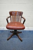 A 20TH CENTURY MAHOGANY SWIVEL OFFICE CHAIR, with open armrests, leather upholstered seat, raised on