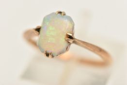 A YELLOW METAL OPAL RING, set with a rectangular cut white opal cabochon (large chip), in a double