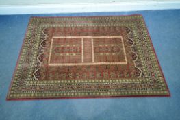 THE ULTIMATE RUG Co, A RED GROUND RECTANGULAR 100 PERCENT POLYPROPYLENE RUG, with repeating