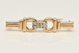 A 9CT GOLD DIAMOND SET BROOCH, snaffle style, set with eight small round brilliant cut diamonds,