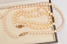 TWO CULTURED PEARL NECKLACES, the first a single strand of pearls, each approximately 6.5mm,