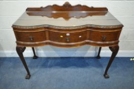 A GEORGIAN STYLE WALNUT SERPENTINE SIDE TABLE, with a raised back, fitted with three frieze drawers,