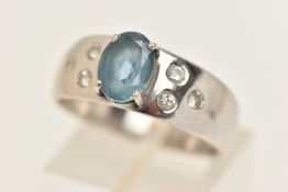 A WHITE METAL AQUAMARINE AND DIAMOND RING, set with an oval cut aquamarine, claw set and flanked