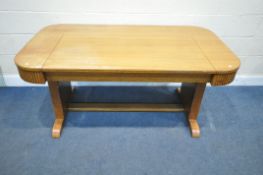 AN ART DECO OAK METAMORPHIC SOFA / TABLE, with foliate upholstery, trestle style supports, united by