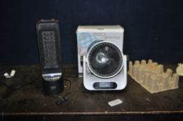 A NEOSTAR OSCILLATING FAN in original packaging with remote and a Black and Decker heater with