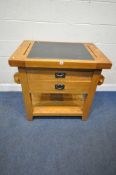 A SOLID OAK FREE STANDING KITCHEN ISLAND, with a black granite insert, two slots, a single handle to