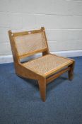 AFTER PIERRE JEANNERET KANGAROO STYLE LOUNGE CHAIR, with a teak frame and cane back and seat,