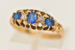 AN EARLY 20TH CENTURY 18CT GOLD GEM SET RING, set with three blue stones assessed as possibly garnet