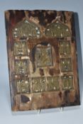 AN ORTHODOX 'INLAID VITA THEOKOTIS ' ICON with eleven brass panels inset into a wooden base with
