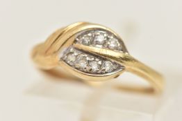 A YELLOW METAL GEM SET LEAF RING, set with colourless paste to a polished band, stamped 585, ring