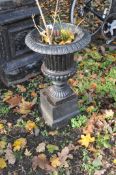 A SMALL EARLY 20th CENTURY CAST IRON CAMPAGNA GARDEN URN ON STAND with fluted detail to bowl and egg