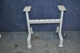 A PAINTED STEEL MACHINE STAND with wheel to one end and adjustable feet to the other, holes for