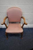 AN EARLY 20TH CENTURY ARMCHAIR, with pink upholstery, swept open armrests, raised on front