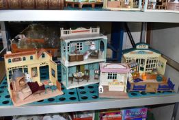 FOUR SYLVANIAN FAMILIES PLAYSETS comprising 'Village Pizzeria,' 'Grocery Market,' Sweet Store,'