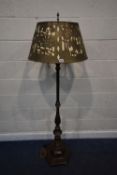 A BRASS STANDARD LAMP, with a hexagonal stepped base on bun feet, the pierced brass shade