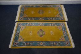 TWO MATCHING YELLOW GROUND RECTANGULAR CHINESE WOOLLEN RUGS, largest rug 164cm x 87cm, condition