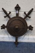 A CAST IRON WALL HANGING COAT / HAT RACK, with four arms, in the form of a shield and crossed