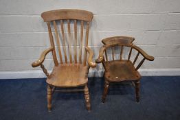 A 20TH CENTURY BEECH WINDSOR ARMCHAIR, with scrolled armrests, raised on turned legs, united by