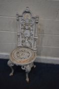 A WHITE PAINTED VICTORIAN CAST IRON CHAIR, with fruit and vine details, surrounding an oval plaque